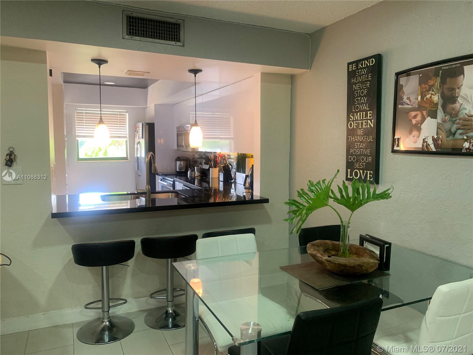 4018 Del Rio Way, Unit 4018 Sunrise, FL 33351 - Photo 12 of 94 a living room with furniture and a potted plant
