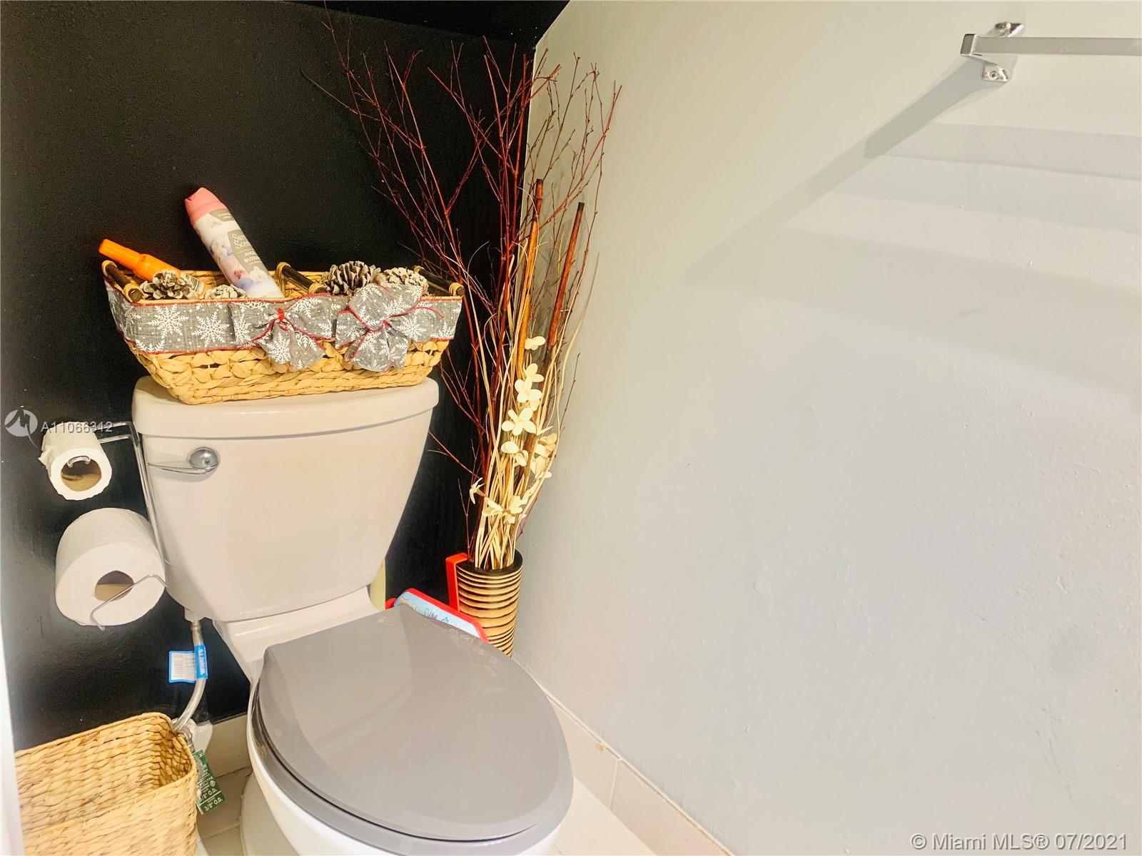 4018 Del Rio Way, Unit 4018 Sunrise, FL 33351 - Photo 26 of 94 a white toilet sitting next to a shower curtain