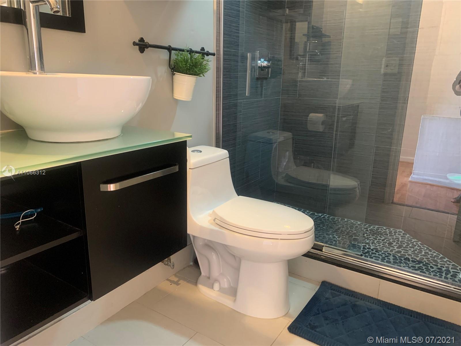 4018 Del Rio Way, Unit 4018 Sunrise, FL 33351 - Photo 27 of 94 a bathroom with a sink a toilet a shower and a bathtub