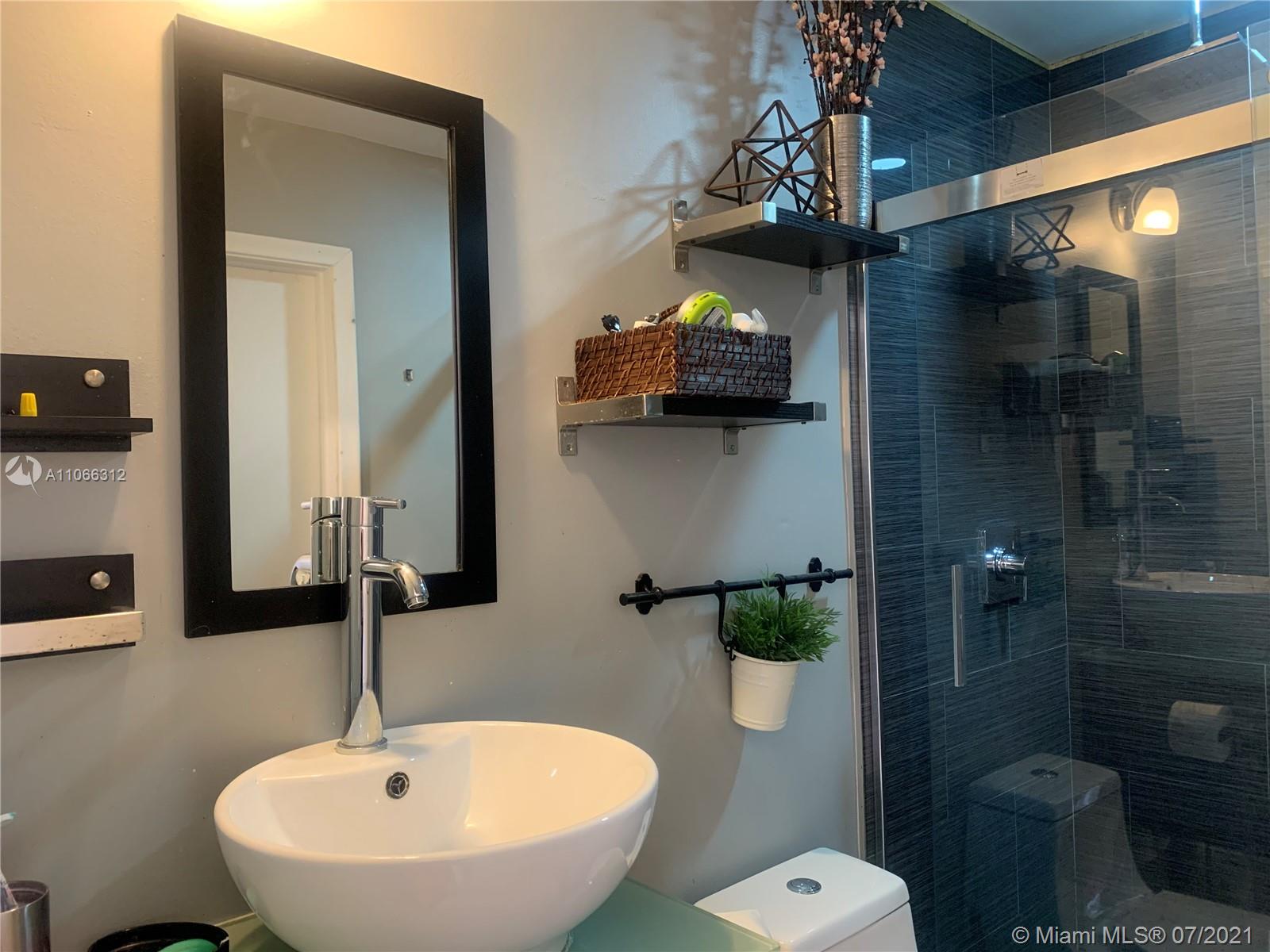 4018 Del Rio Way, Unit 4018 Sunrise, FL 33351 - Photo 29 of 94 a bathroom with a sink and mirror