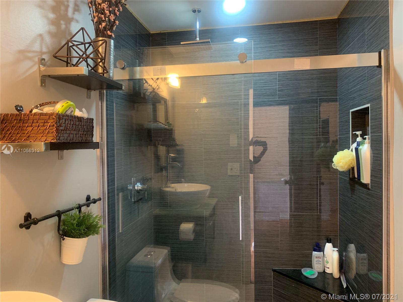 4018 Del Rio Way, Unit 4018 Sunrise, FL 33351 - Photo 30 of 94 a bathroom with a toilet and a shower