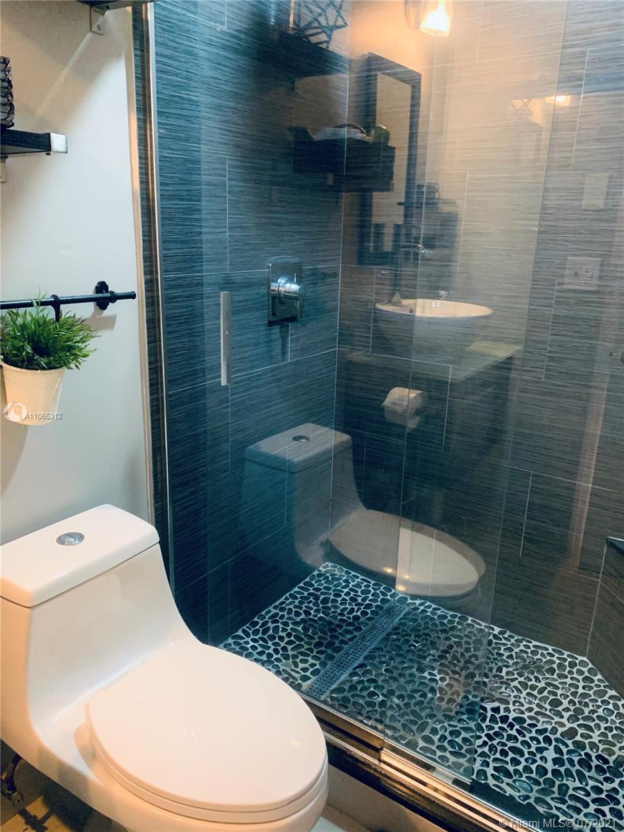 4018 Del Rio Way, Unit 4018 Sunrise, FL 33351 - Photo 31 of 94 a bathroom with a toilet and a shower