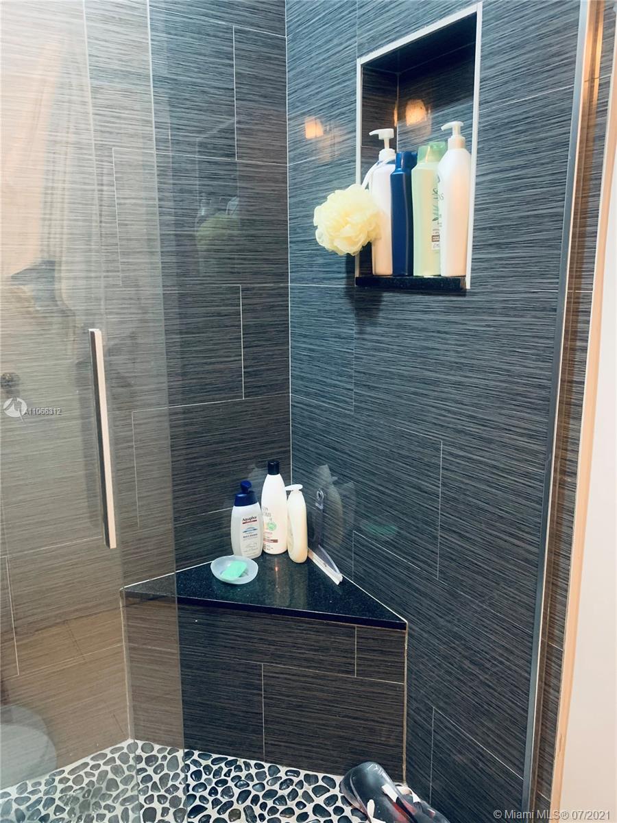 4018 Del Rio Way, Unit 4018 Sunrise, FL 33351 - Photo 32 of 94 a bathroom with a sink and a mirror