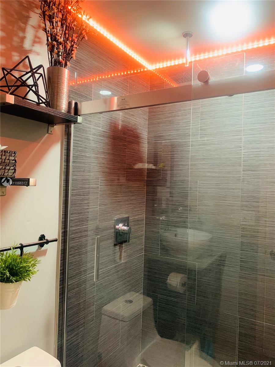 4018 Del Rio Way, Unit 4018 Sunrise, FL 33351 - Photo 40 of 94 a bathroom with a shower and a toilet
