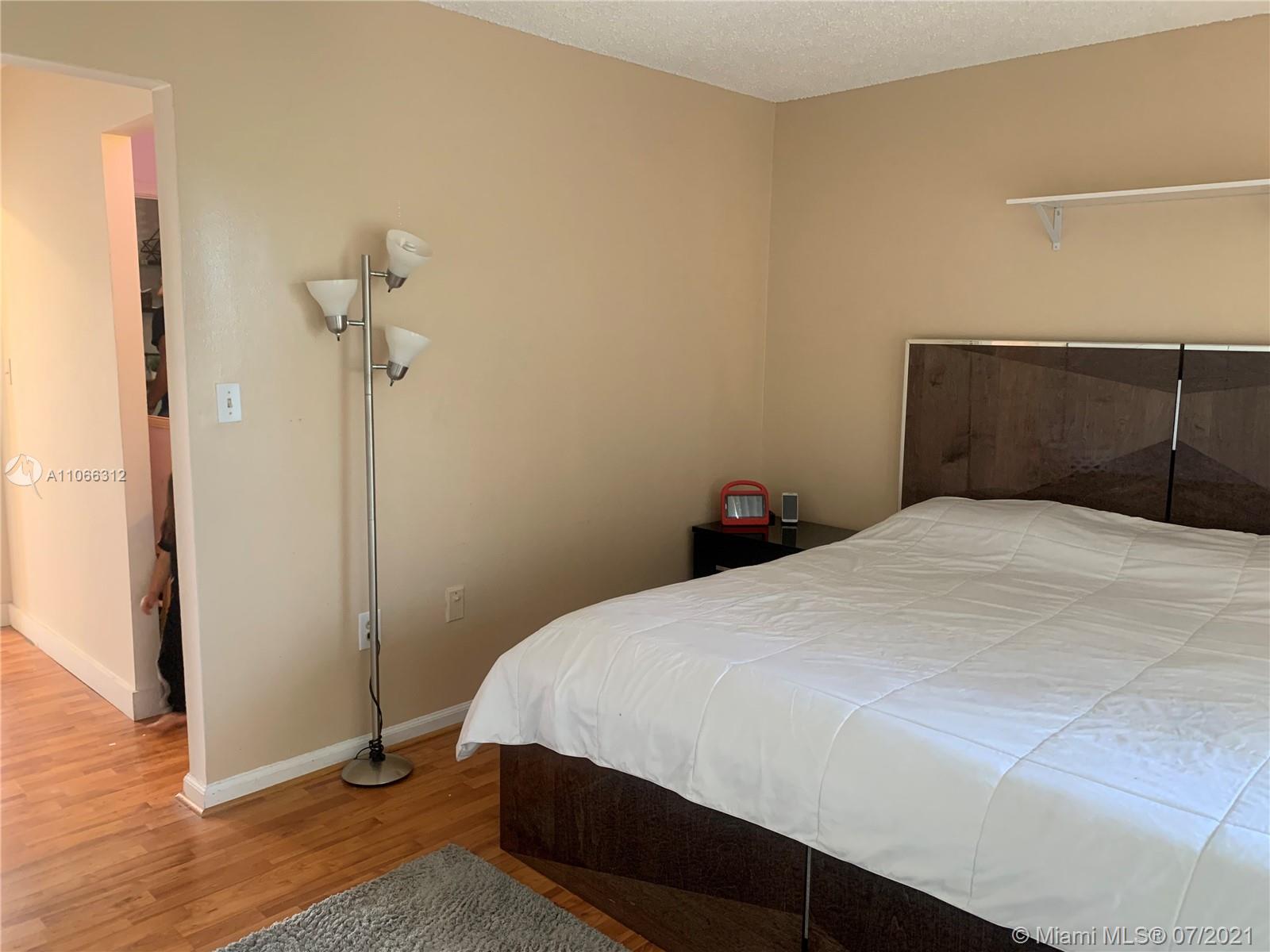 4018 Del Rio Way, Unit 4018 Sunrise, FL 33351 - Photo 46 of 94 a bedroom with a bed and a table
