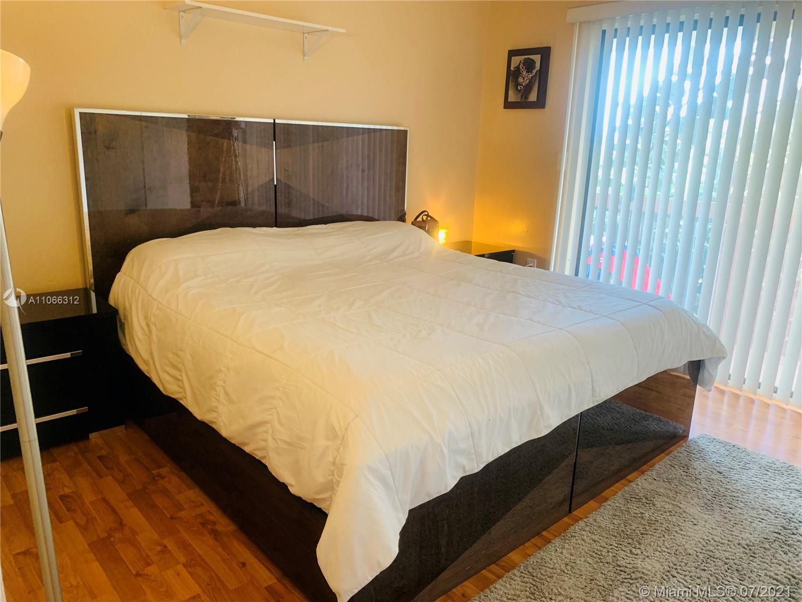 4018 Del Rio Way, Unit 4018 Sunrise, FL 33351 - Photo 48 of 94 a bed sitting in a bedroom next to a window
