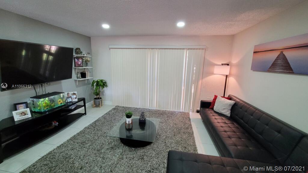 4018 Del Rio Way, Unit 4018 Sunrise, FL 33351 - Photo 6 of 94 a living room with furniture and a flat screen tv