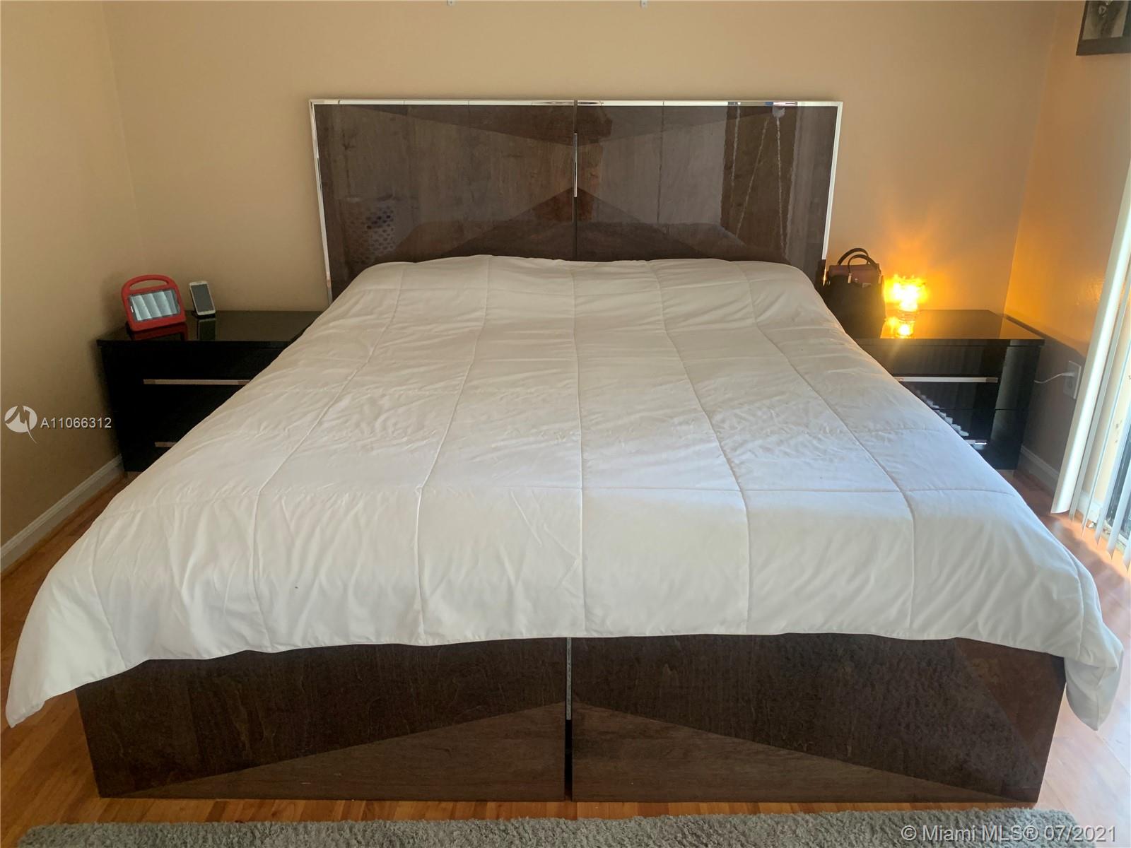 4018 Del Rio Way, Unit 4018 Sunrise, FL 33351 - Photo 51 of 94 a bed sitting in a bedroom and lamp