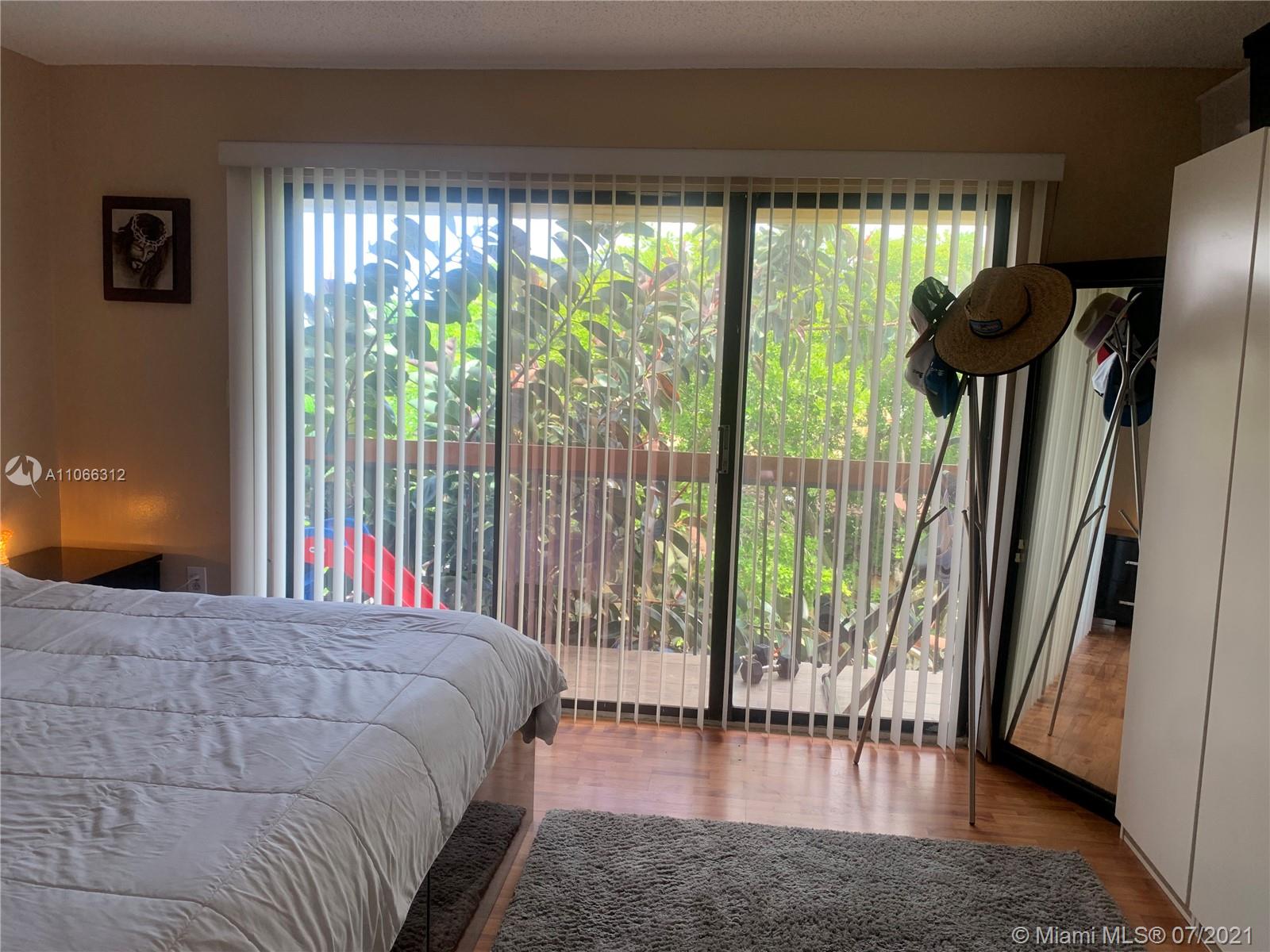 4018 Del Rio Way, Unit 4018 Sunrise, FL 33351 - Photo 52 of 94 a bedroom with a bed and a large window