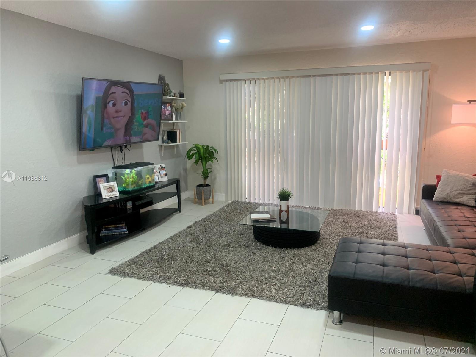 4018 Del Rio Way, Unit 4018 Sunrise, FL 33351 - Photo 7 of 94 a living room with furniture and a flat screen tv