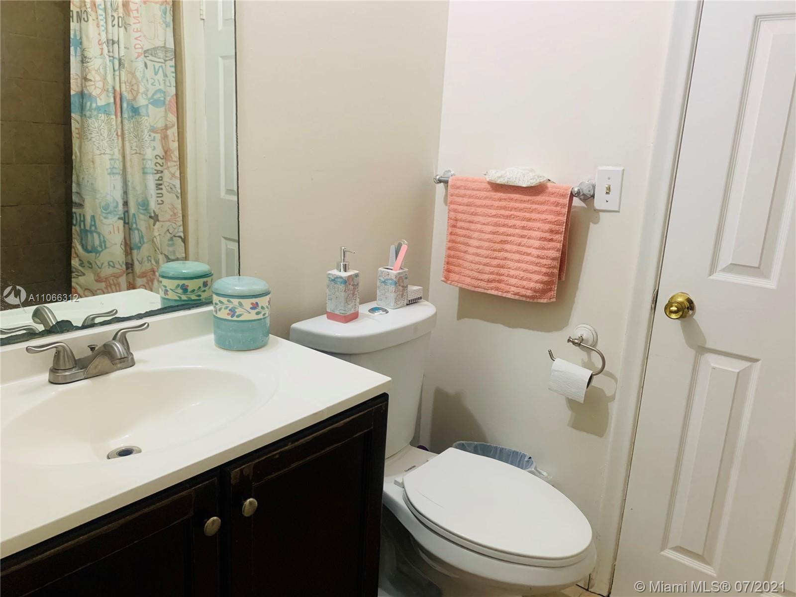 4018 Del Rio Way, Unit 4018 Sunrise, FL 33351 - Photo 72 of 94 a bathroom with a sink a toilet and a mirror