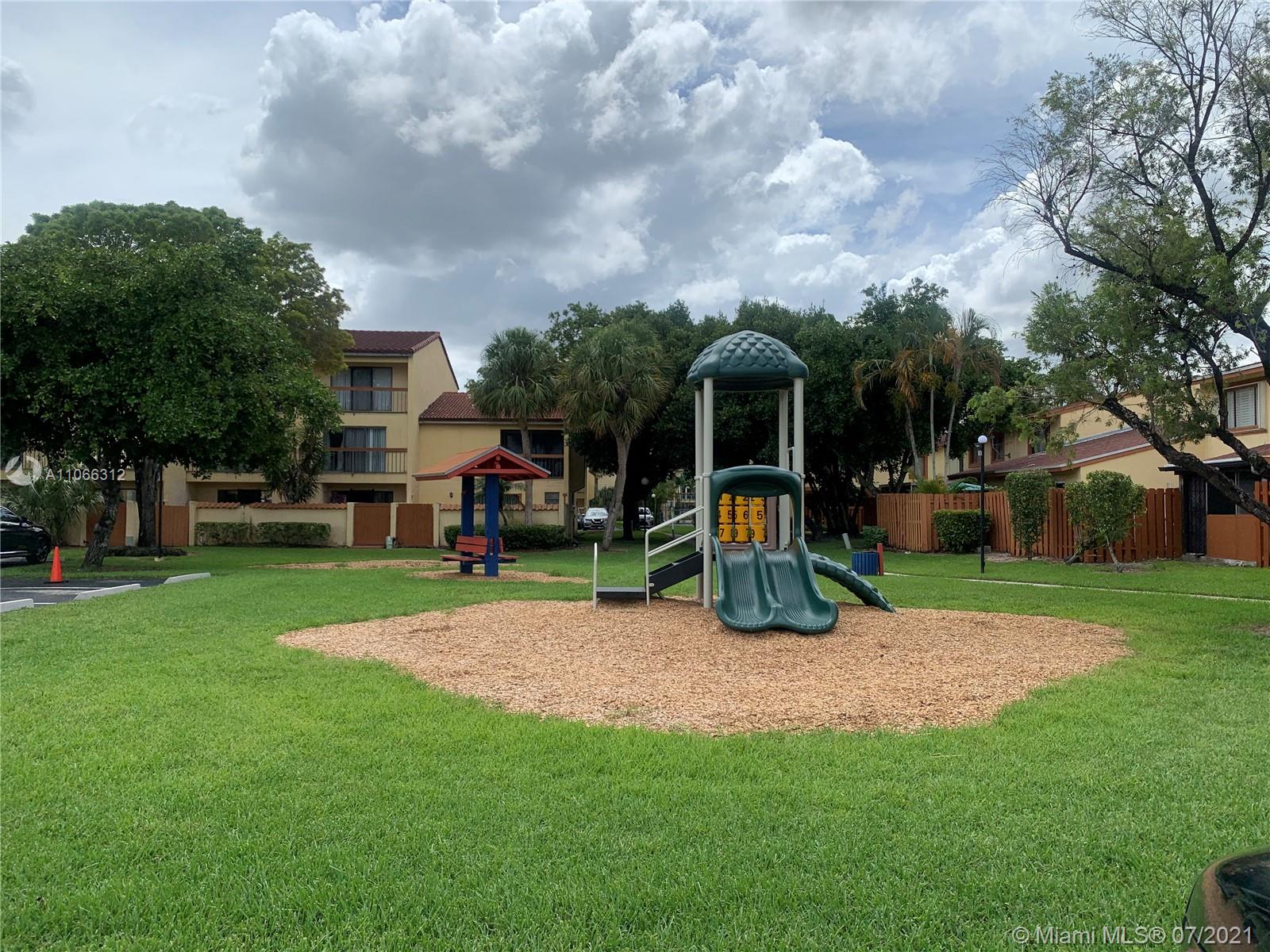 4018 Del Rio Way, Unit 4018 Sunrise, FL 33351 - Photo 88 of 94 a view of a park with swings and slides