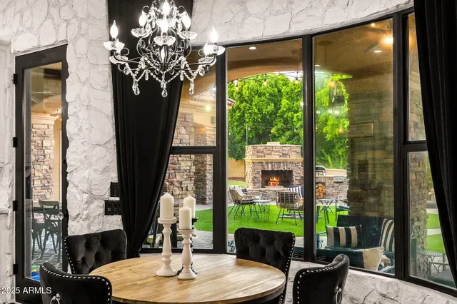 a open kitchen with stainless steel appliances kitchen island a dining table and chairs