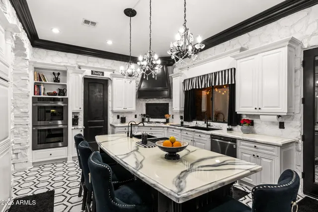 a view of a hallway with couches and wooden floor