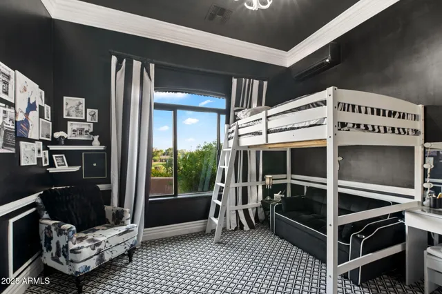 a bedroom with a bed and a chandelier