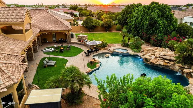 an aerial view of a house with yard swimming pool and outdoor seating