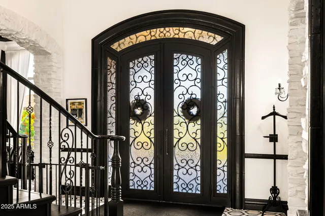 a view of a hallway with wooden floor and furniture