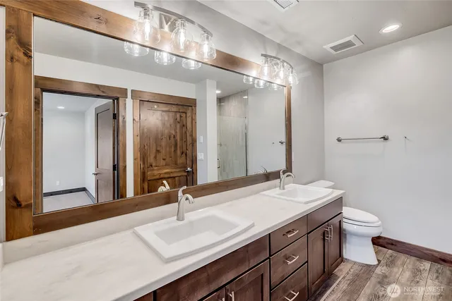 a bathroom with a double vanity sink and a mirror