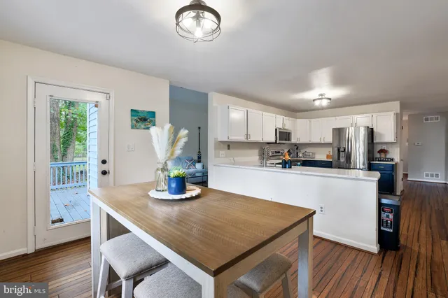 a kitchen with a sink cabinets and wooden floor