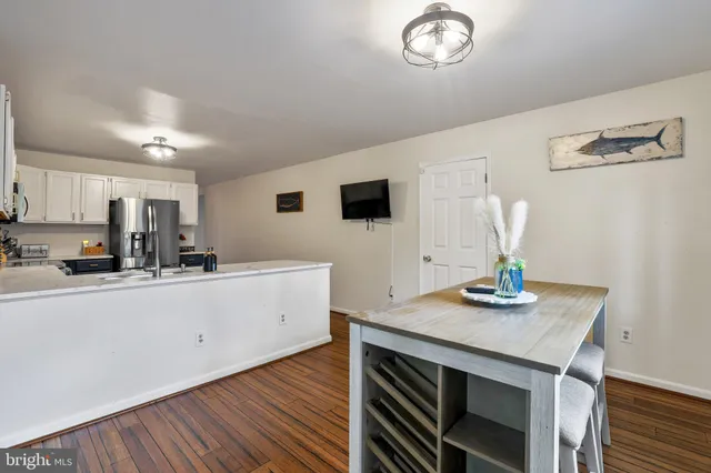 a kitchen with stainless steel appliances a refrigerator stove microwave and cabinets