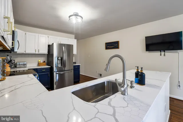 a kitchen with stainless steel appliances granite countertop wooden cabinets stove top oven and sink