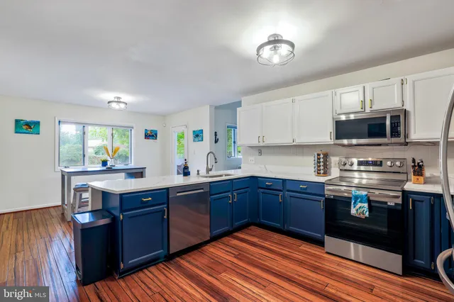 a kitchen with stainless steel appliances granite countertop a refrigerator stove and sink