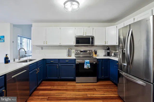 a bathroom with a granite countertop toilet a sink and a mirror