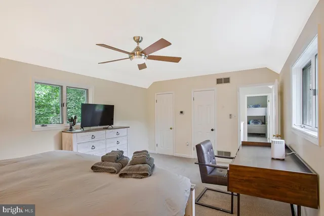 a bedroom with furniture and a flat screen tv