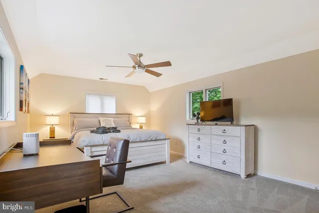 a bedroom with a bed and a table