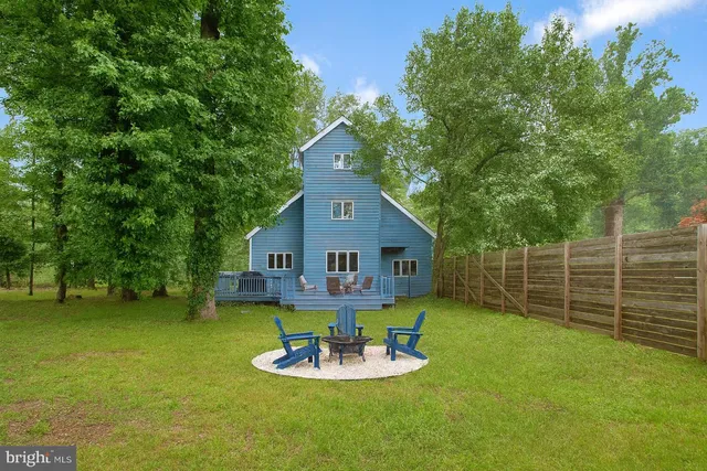 a view of a deck with furniture and garden