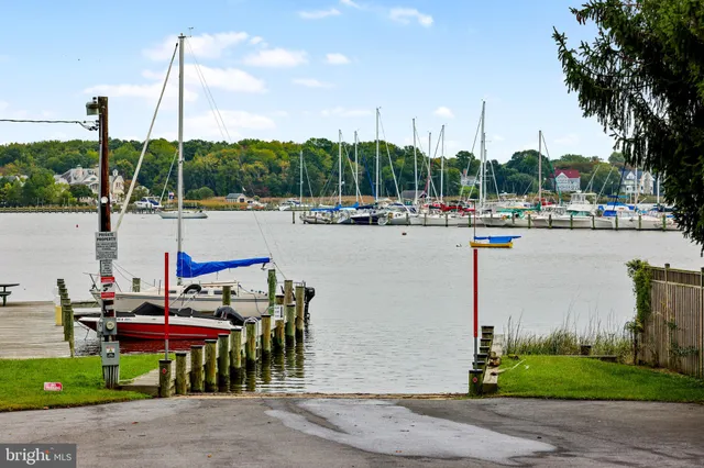 a view of outdoor space with patio furniture and water view