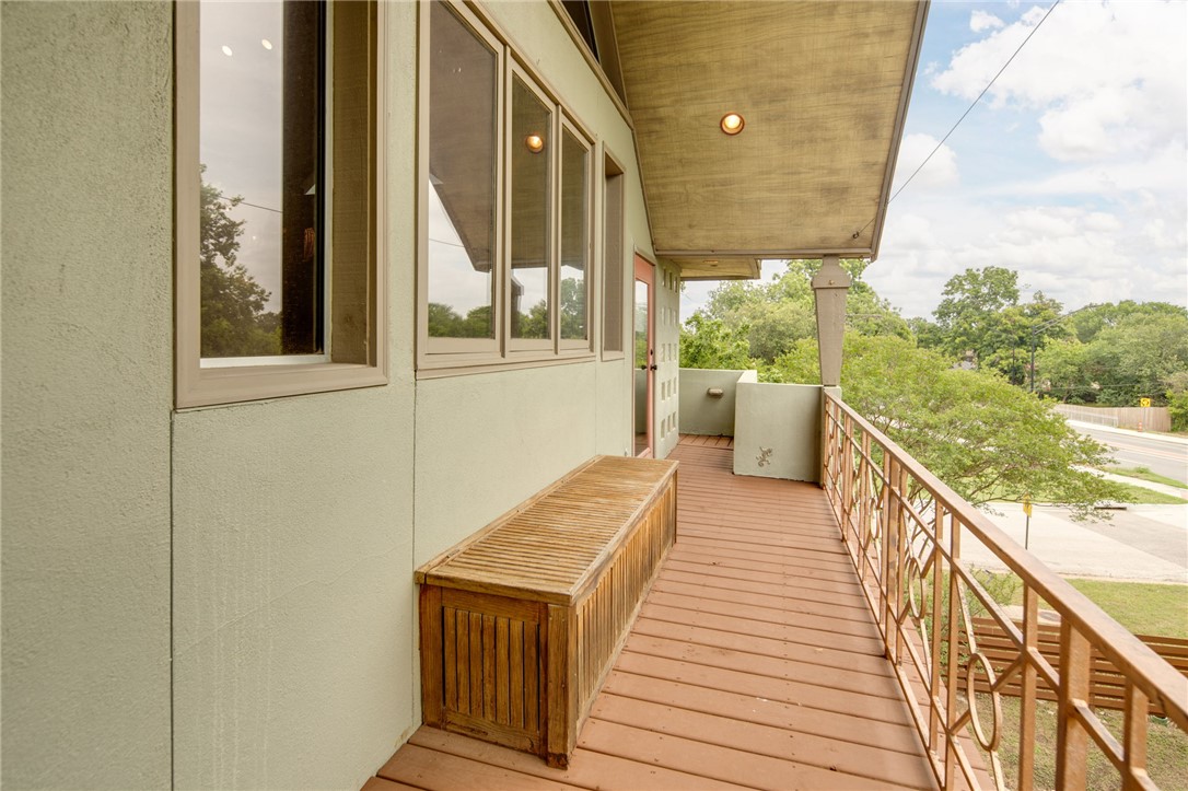 1015 East 24th Street Bryan, TX 77803 - Photo 35 of 43 a view of a balcony with wooden floor and iron stairs