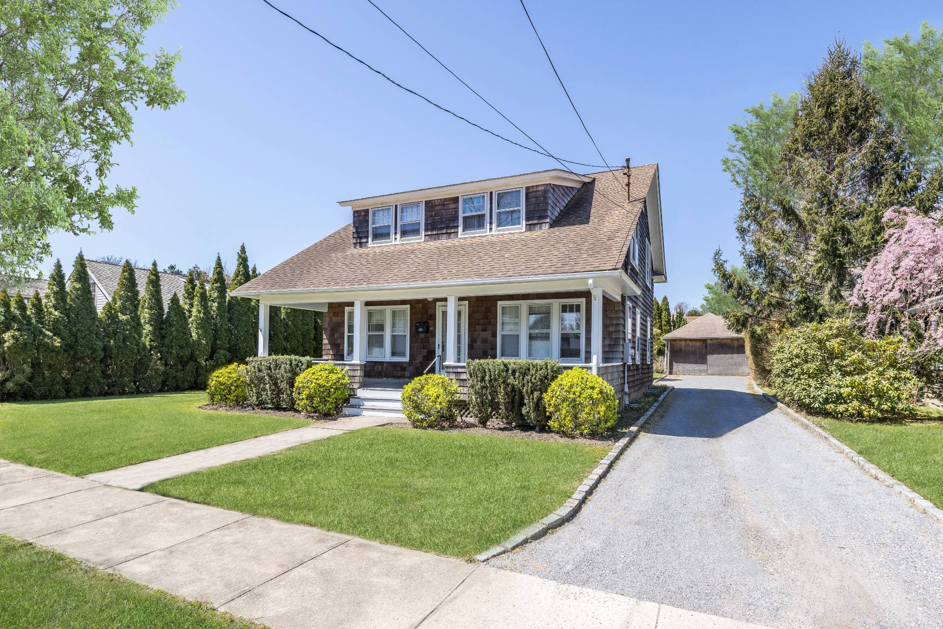 a front view of a house with a garden and porch