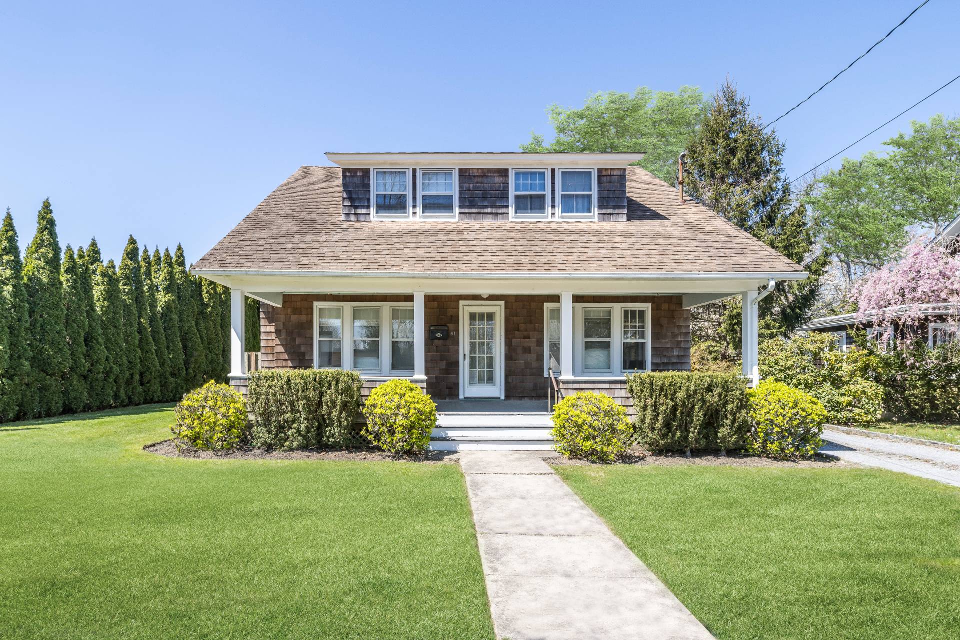 41 Sherrill Road East Hampton, NY 11937 - Photo 4 of 24 a front view of a house with garden