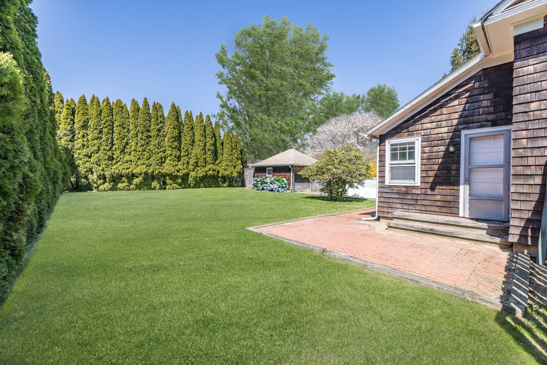 41 Sherrill Road East Hampton, NY 11937 - Photo 6 of 24 a view of a house with backyard and a tree