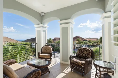 a bathroom with a double vanity sink a large mirror and a bathtub