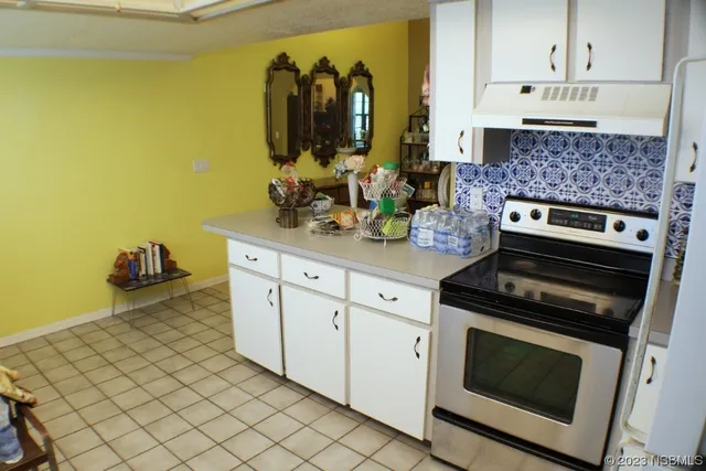 a kitchen with stainless steel appliances a stove a microwave and cabinets