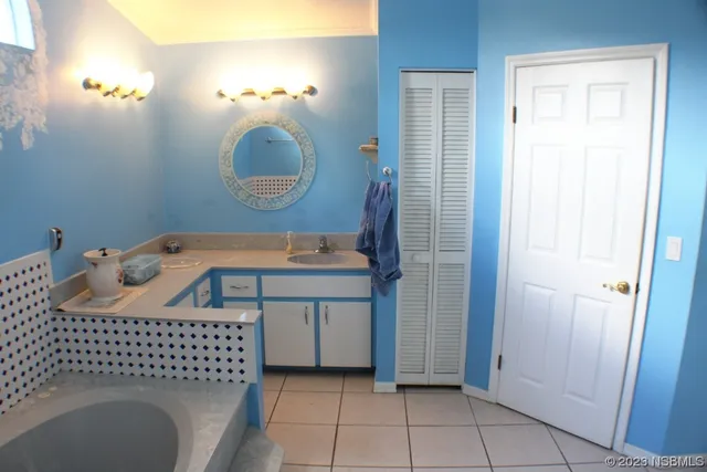 a bathroom with a sink a mirror and vanity