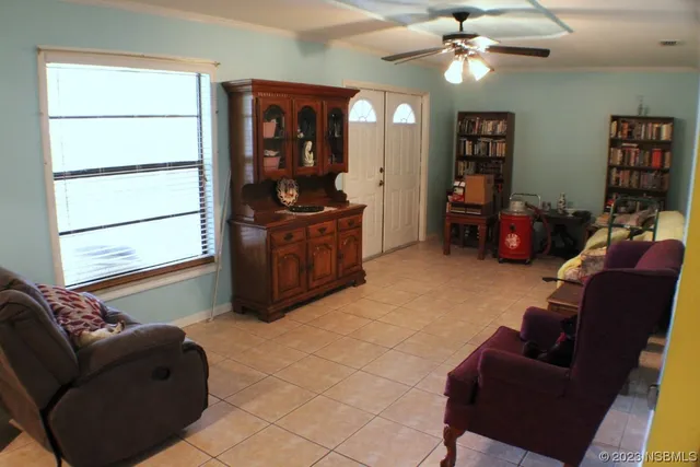 a living room with furniture a lamp and a window