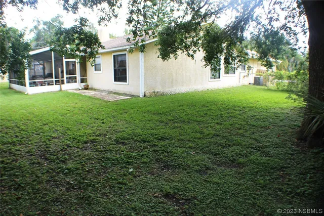a view of a house with yard and sitting area