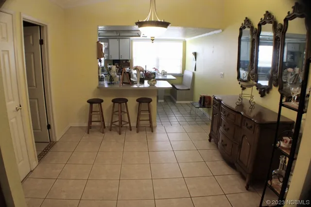 a dining room with furniture and a chandelier