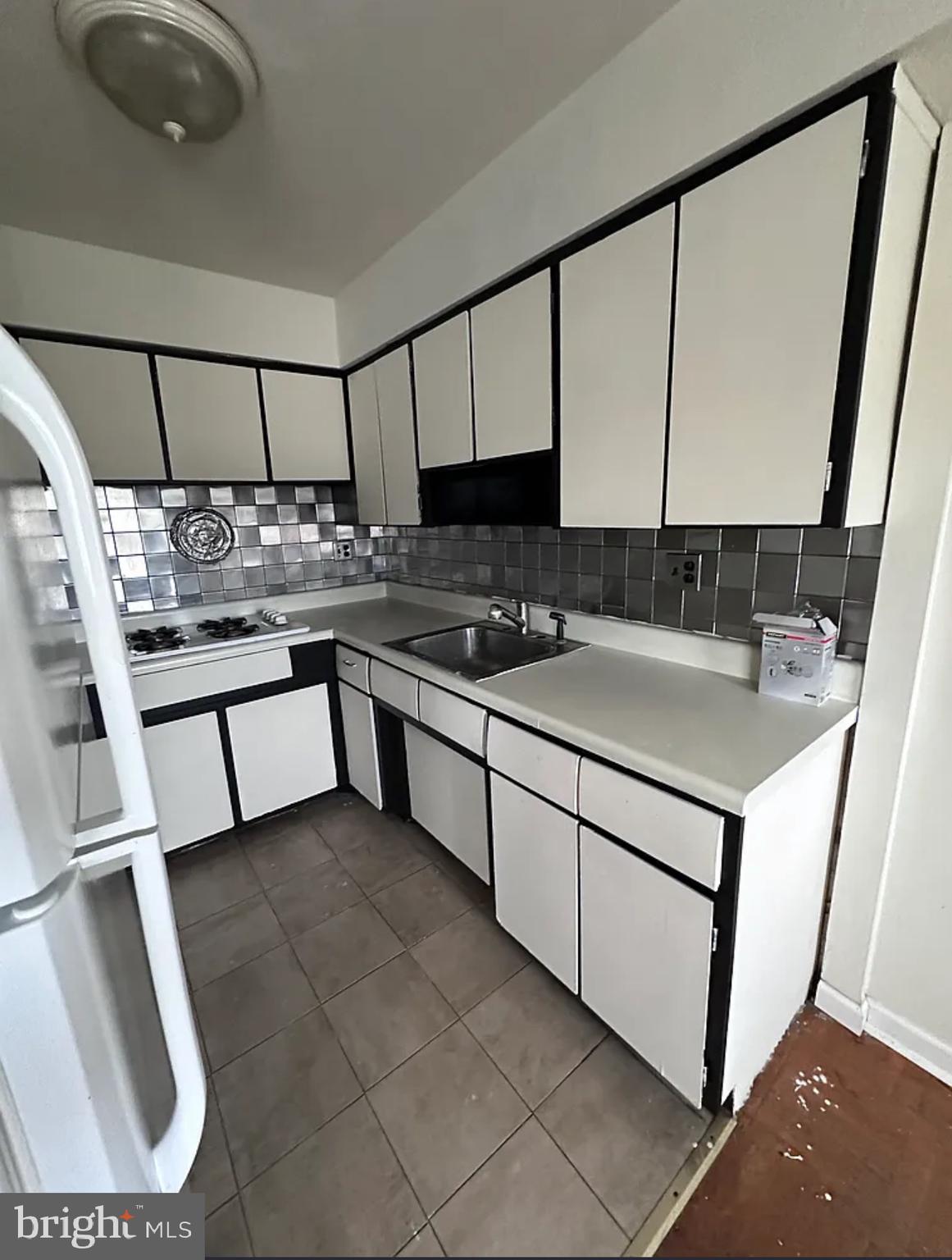 10031 Bridle Road Philadelphia, PA 19116 - Photo 14 of 32 a kitchen with a sink a stove and a refrigerator