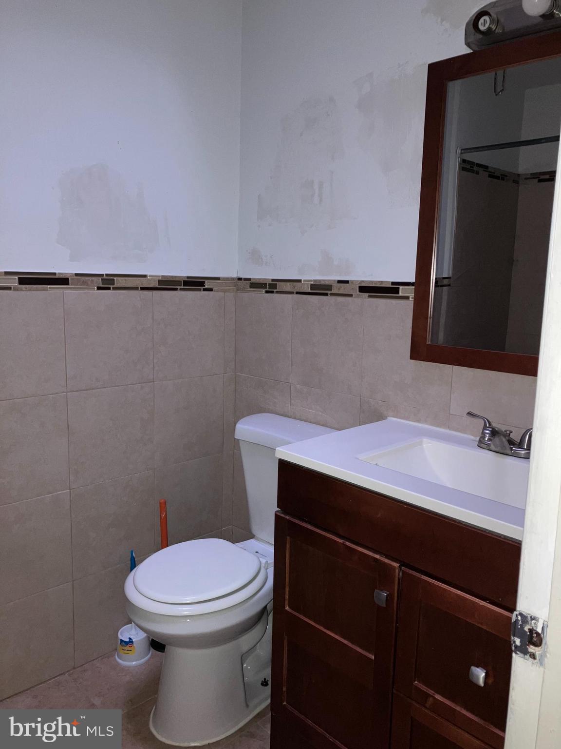 10031 Bridle Road Philadelphia, PA 19116 - Photo 24 of 32 a bathroom with a sink a toilet and a mirror