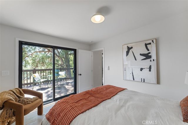 a bedroom with a bed and glass window