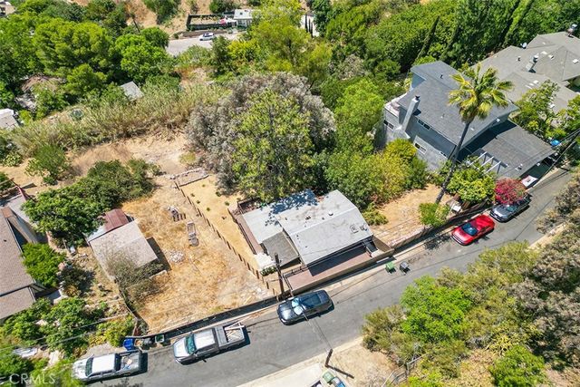 an aerial view of a backyard with chairs