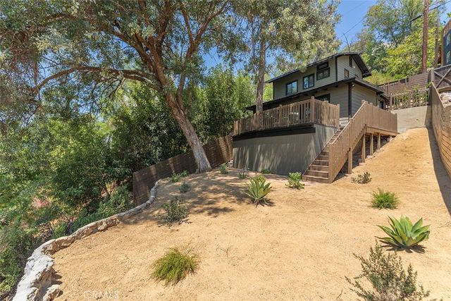 a view of a house with a yard covered in snow