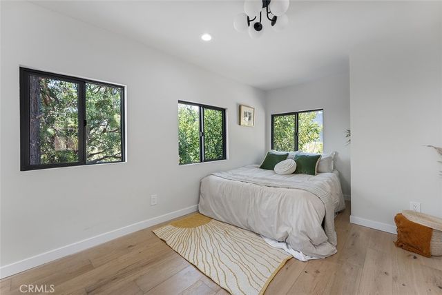 a bedroom with a large bed and a window