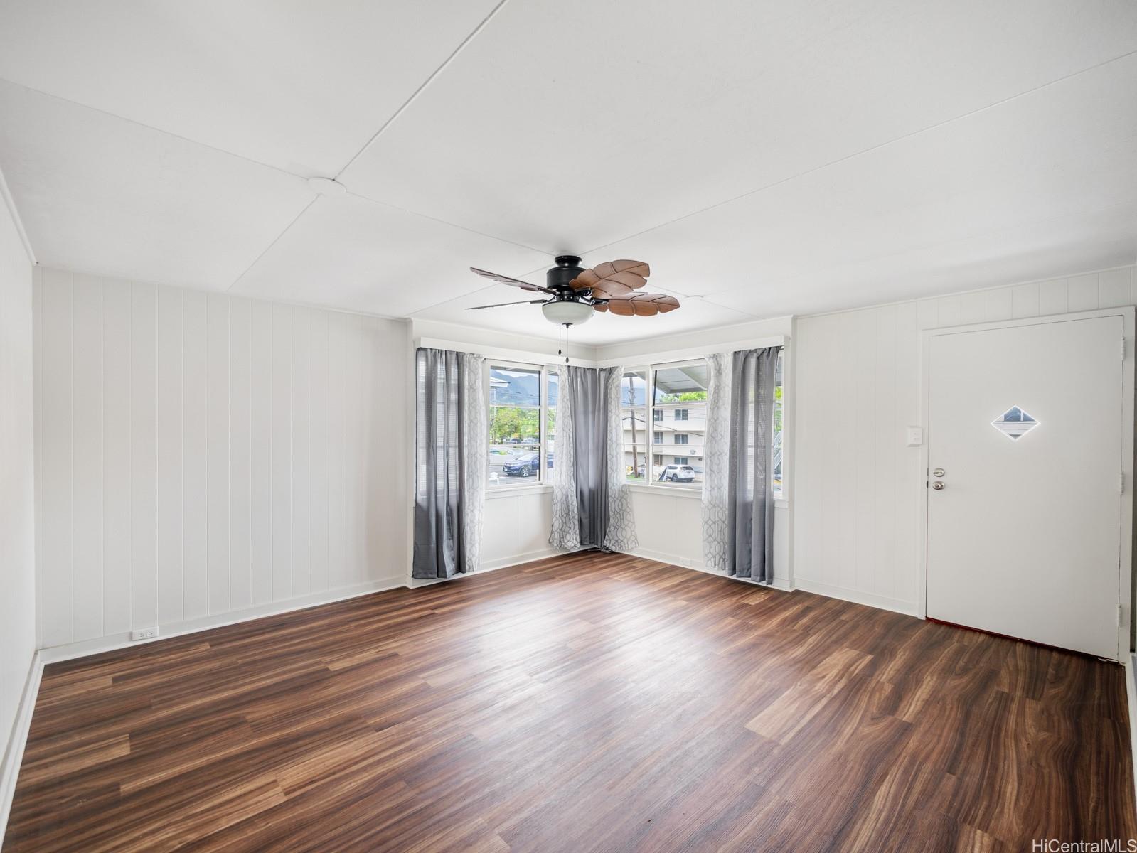 45-510 Pahia Road Kaneohe, HI 96744 - Photo 2 of 24 a view of an empty room with wooden floor and a window