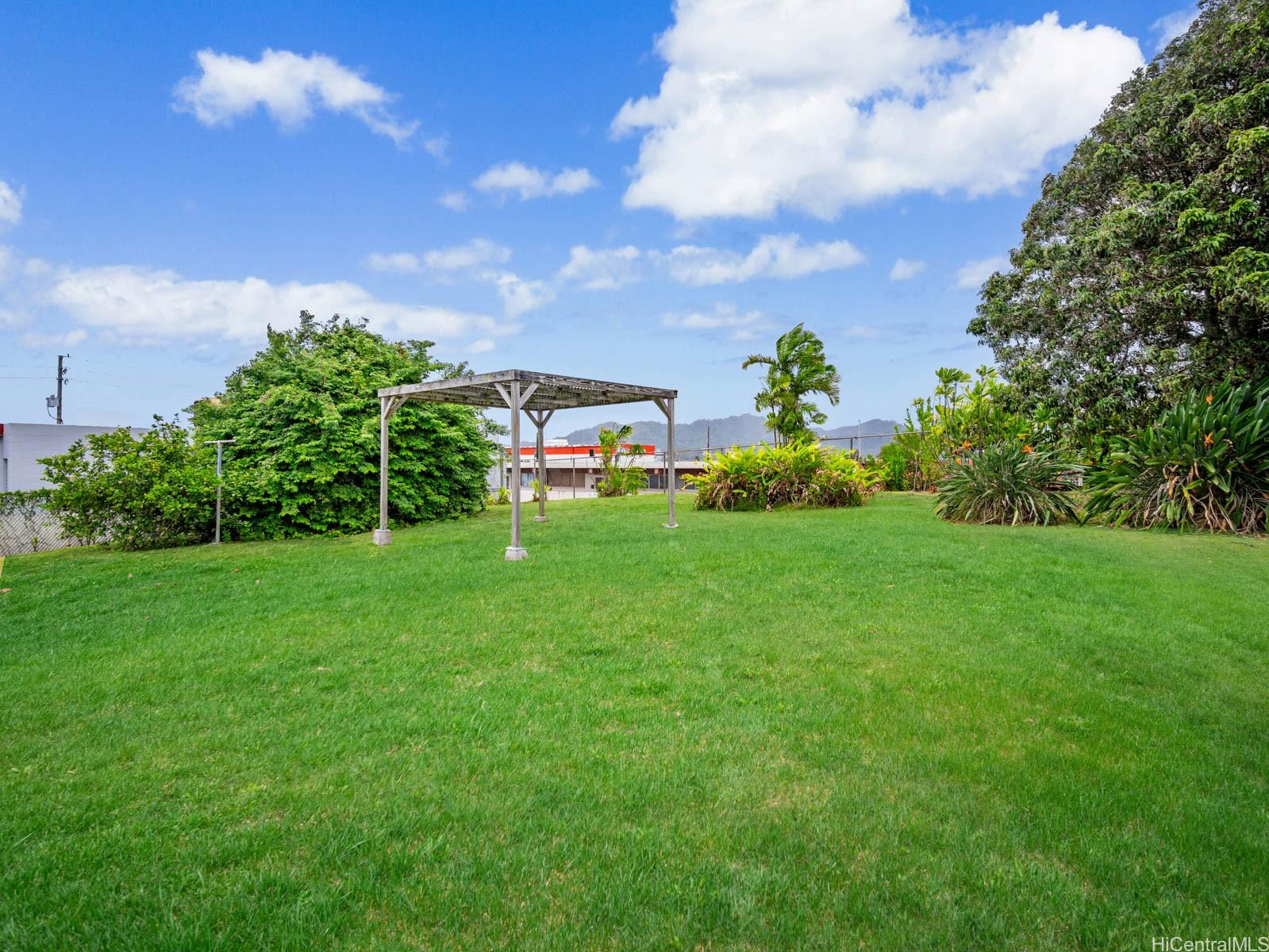 45-510 Pahia Road Kaneohe, HI 96744 - Photo 21 of 24 a view of a garden with a building in the background