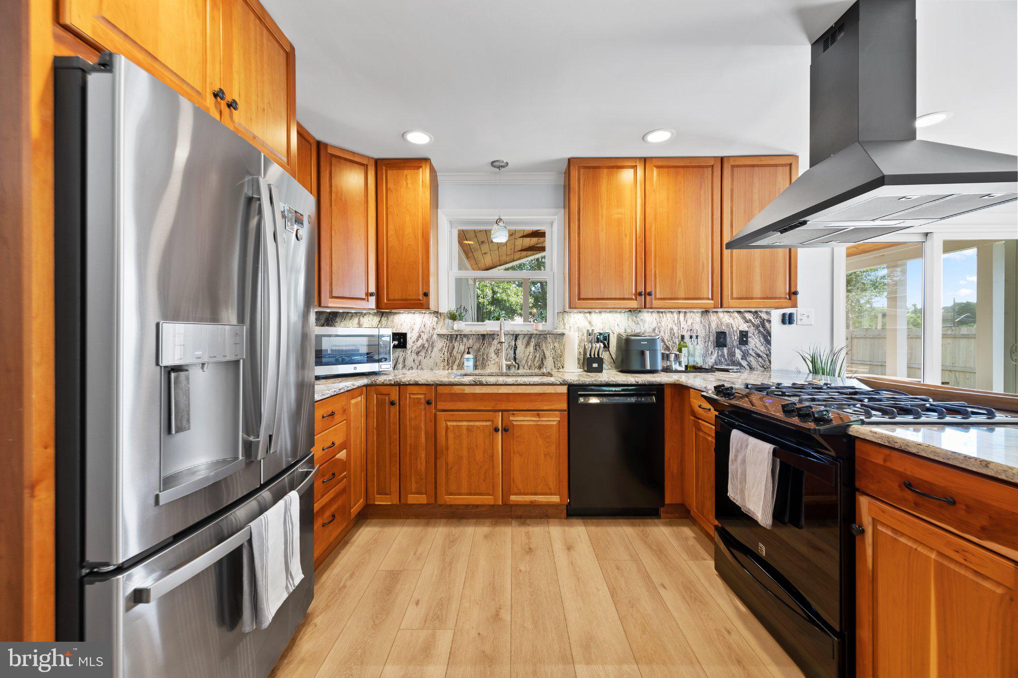 6705 New Hope Drive Springfield, VA 22151 - Photo 24 of 67 Modern kitchen with warm wood accents.